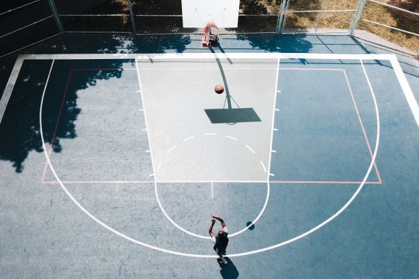 header photo of a young person playing basketball for drug court article